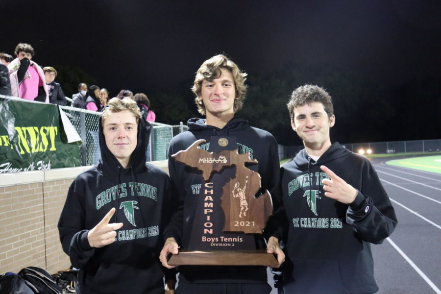 Team captains senior RJ Carrell, senior Dylan Brown, and junior Nolen Kovan hold the Division 2 Boys Tennis State Championship trophy, before being honored during the football game’s halftime on October 22. 