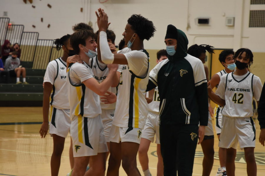 The+Groves+basketball+team+celebrates+their+win+over+rival+Seaholm+with+junior+guard+Jack+Abbott+after+he+scored+a+game-winning+layup.+%E2%80%9CIt+was+so+fun+playing+this+game.+Good+sportsmanship+between+Groves+and+Seaholm+and+a+close+game+is+a+regular+occurrence+for+us%2C%E2%80%9D+Abbott+said.