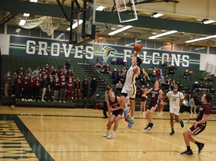 Senior center Nick Lurz (#5) leaps into the air and throws down a thunderous slam dunk on the fast break. This play acted as a turning point in the game. Lurz scored six points, had ten rebounds, and had three assists. 