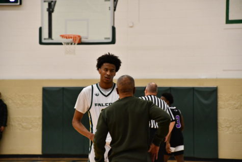 Groves senior forward Quinton Steele (#22) talks to coach Benny White during Groves’ free throws. “We have got to get certain people to step up, and be confident in themselves, and today we didn’t have that. We will learn from it. We are going to watch some film and let them see what they did wrong,” White said.
