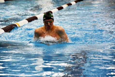 On January 25 in a meet versus Seaholm, Groves sophomore Angus MacDonald leads the pack in the 100-meter breaststroke. MacDonald won the race by over 4.5 seconds. I was telling myself to toughen up and bear through the pain because I knew my team needed me, MacDonald said.