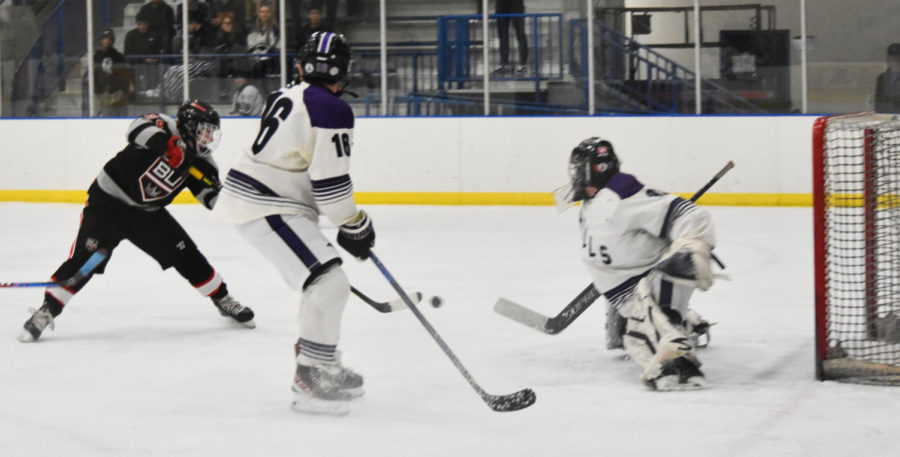 Groves junior forward Leo Kepler buries a rebound into the net for his first varsity goal. This gave the Kings a 4-1 lead versus Bloomfield Hills on January 13.