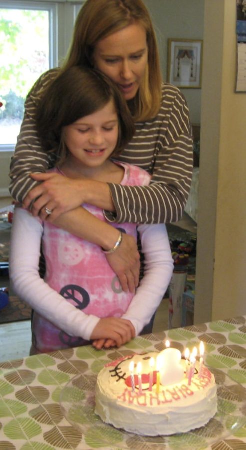 With a smile spread across my face, I prepare to blow out the candles on my eighth birthday cake during October of 2012. My mom stands behind in admiration, with her arms wrapped around me