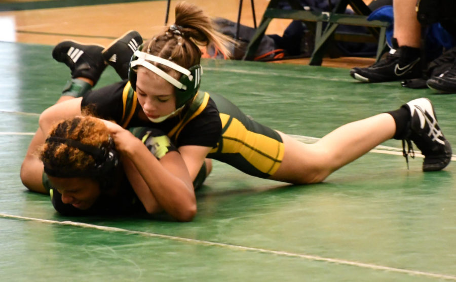 Freshman Samantha Koch pins her West Bloomfield opponent after running a half nelson during a match on January 26. “The match can end one of two ways. The first way is by pinning someone, which is putting them on their back. If you pin someone, you dont wrestle for the other periods that you have left. Its just over. Or, it could go to the end of the third period, and just end based on points,” Koch said.