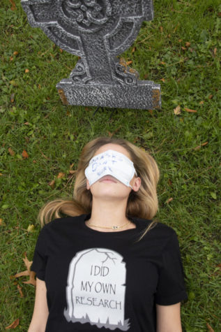 I lay in the grass under a tombstone, imitating the death of yet another anti-vaxxer. The message engraved on the tombstone on the shirt, “I Did My Own Research”, repeats those who deny science and to ignore the advice of medical experts to do their own “Google” searches. This mentality is detrimental to our community as it causes the continuous spread of misinformation and repeatedly calls for the end of the very practices that can end this pandemic..  