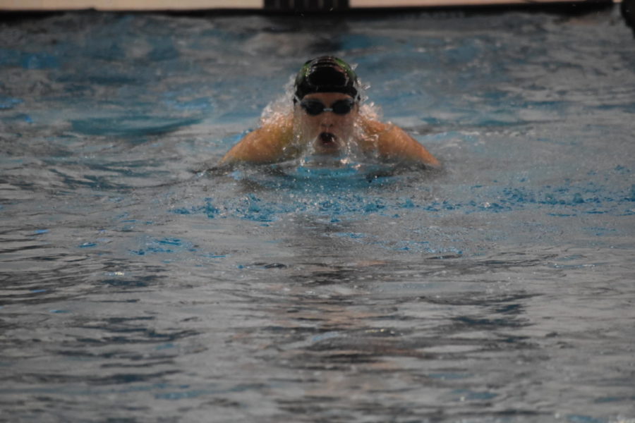 Senior Karen Austin propels herself out of the water at the league meet on November 3. Austin competed in the 200 free, 100 fly, 200 free relay, and 400 free relay.