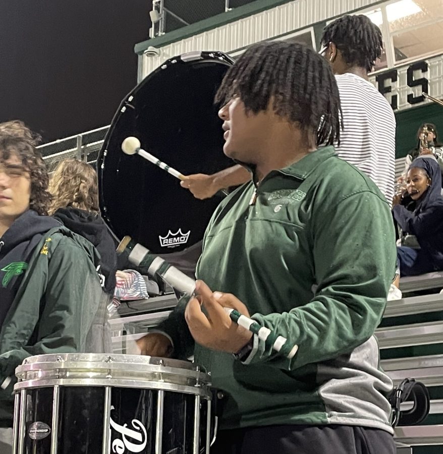 Senior+Norman+Hurns%2C+drumline+section+leader%2C+leads+the+band+through+the+Groves+annual+Powder+Puff+football+game.+Even+in+the+pouring+rain%2C+Hurns+and+the+band+give+up+their+Friday+nights+to+be+at+the+Stadium+for+every+varsity+home+game.+Hurns+and+the+band+dazzles+the+audience+with+their+musical+talent.