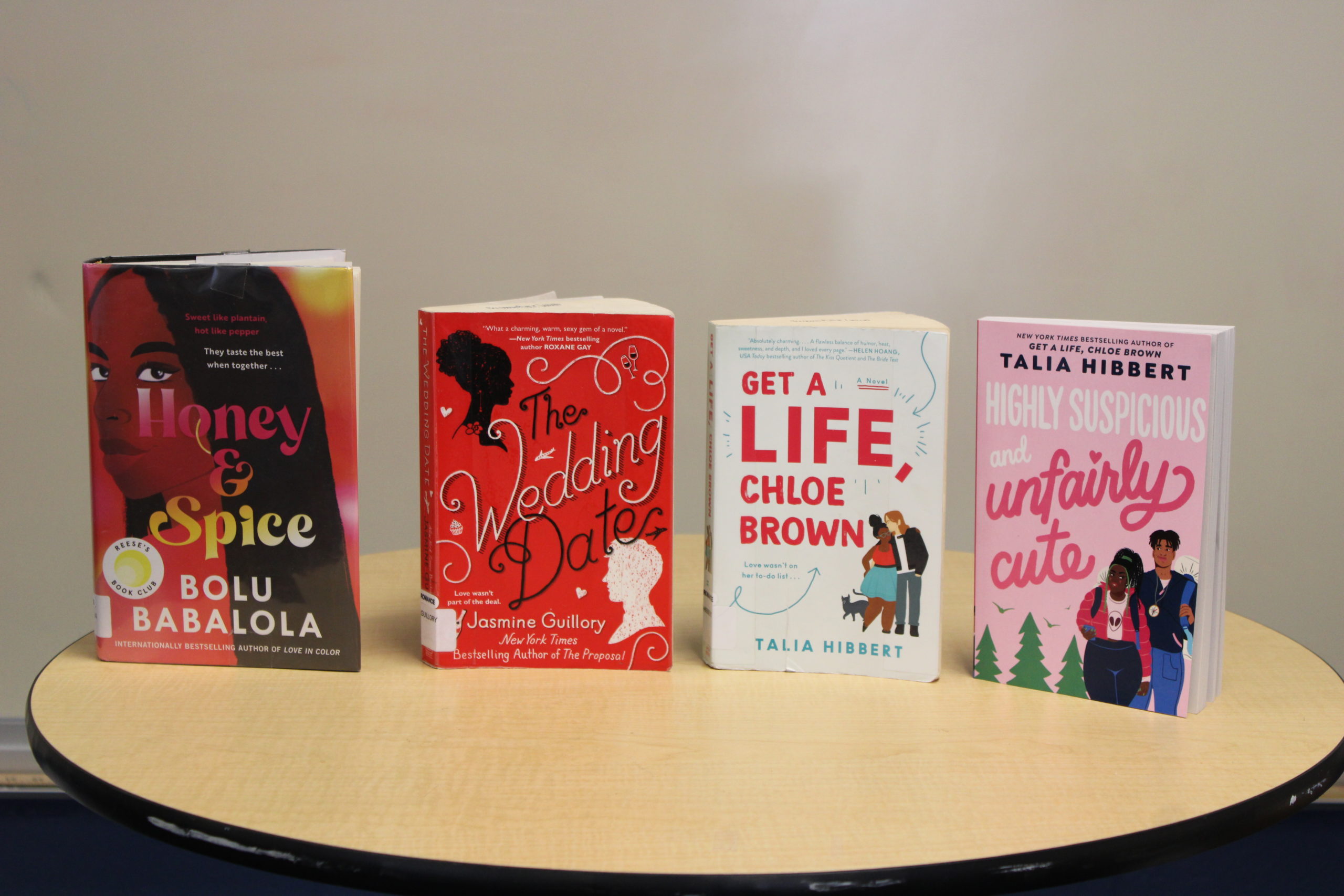 Listed from left to right: Honey & Spice by Bolu Babalola, The Wedding Date by Jasmine Guillory, Get a Life, Chloe Brown by Talia Hibbert, Highly Suspicious and Unfairly Cute by Talia Hibbert