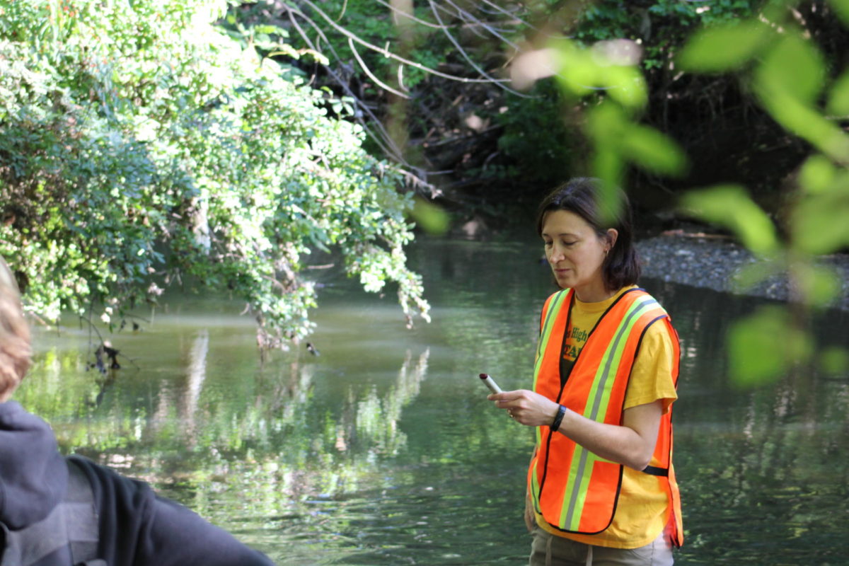 Carrie Nobis, AP Environmental Science teacher at Groves, gathering water samples from the Rogue River on September 14, 2023. These samples would later be taken back to the school for further testing, searching for organic materials such as fecal coliform or larvae.