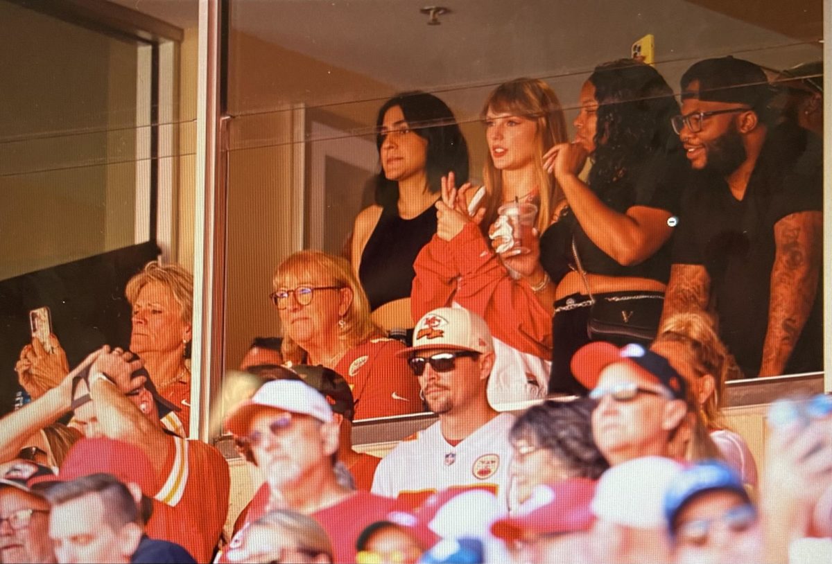 Taylor Swift at the Kansas City Chiefs vs the Chicago Bears game cheering on her alleged beau Travis Kelece. (image is free use via https://www.flickr.com/)
