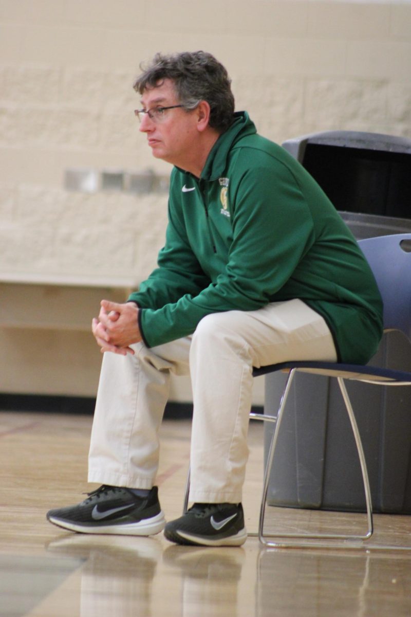 Groves athletic director Tom Flynn sits court side watching Groves girls varsity basketball on January 3.