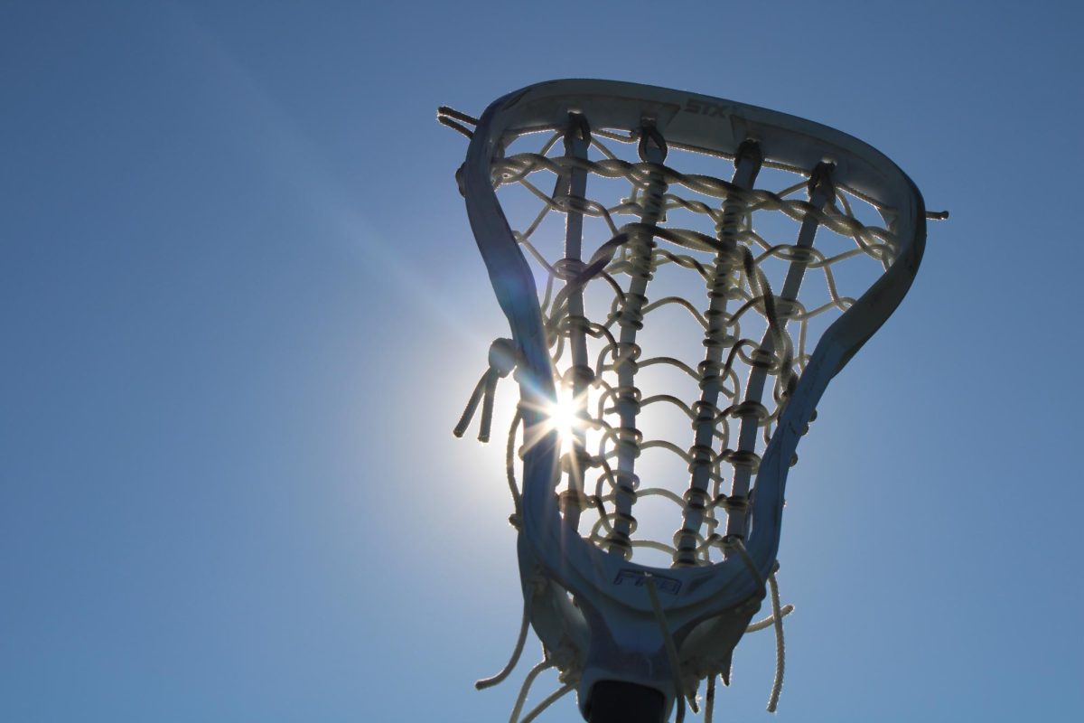 Womens’ lacrosse stick covering the sun on a perfectly clear, sunny day.