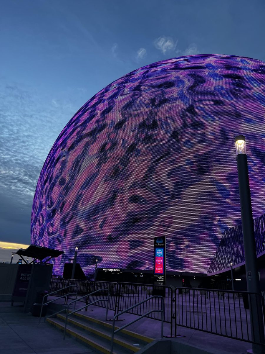 A photo of the outside of the Sphere, lit up purple, the morning of the concert.