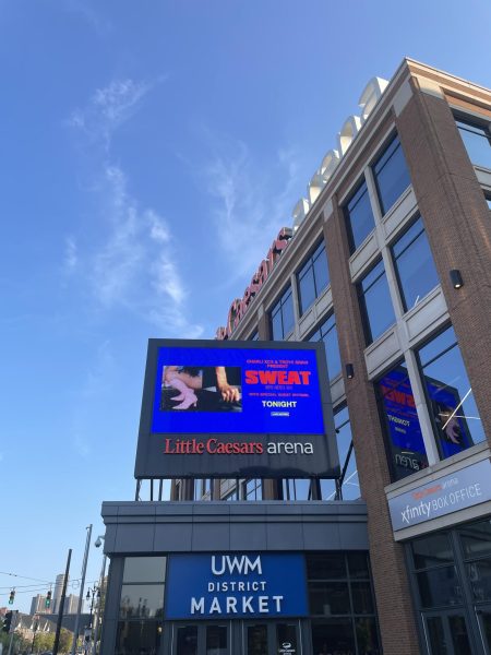 SWEAT Tour sign outside Little Caesars Arena.
