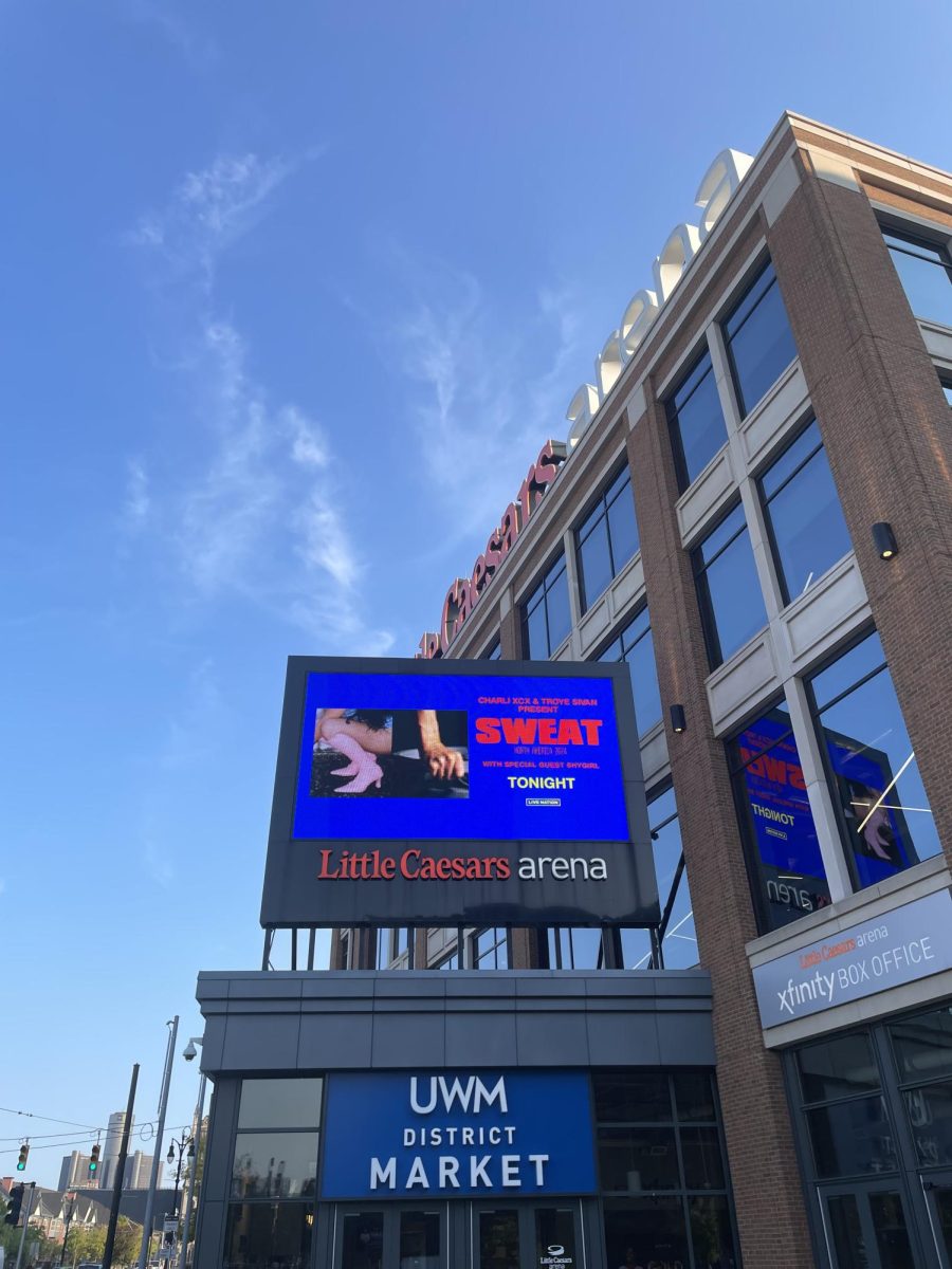 SWEAT Tour sign outside Little Caesars Arena.
