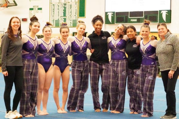 The Birmingham Unified Gymnastics team and coaches pose for a team photo following their big defeat of the Bloomfield Hills Gymnastics team. 