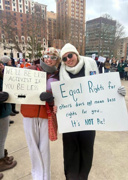  Ireland Kopsch holds a sign that reads “Equal rights for others does not mean less rights for you—it's not pie!” while Delilah Covatta grips a bold message: “We’ll be less activist if you’ll be less sh**!”
