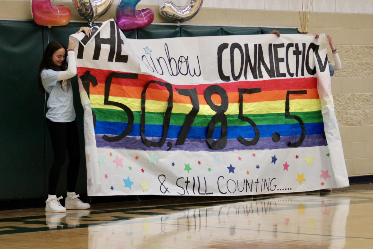 Sophomore Elliana Shulkin holds up a banner presenting the total amount of money raised for the rainbow connection. This year we raised $50,785.50, which surpassed our goal of raising more than last year. 