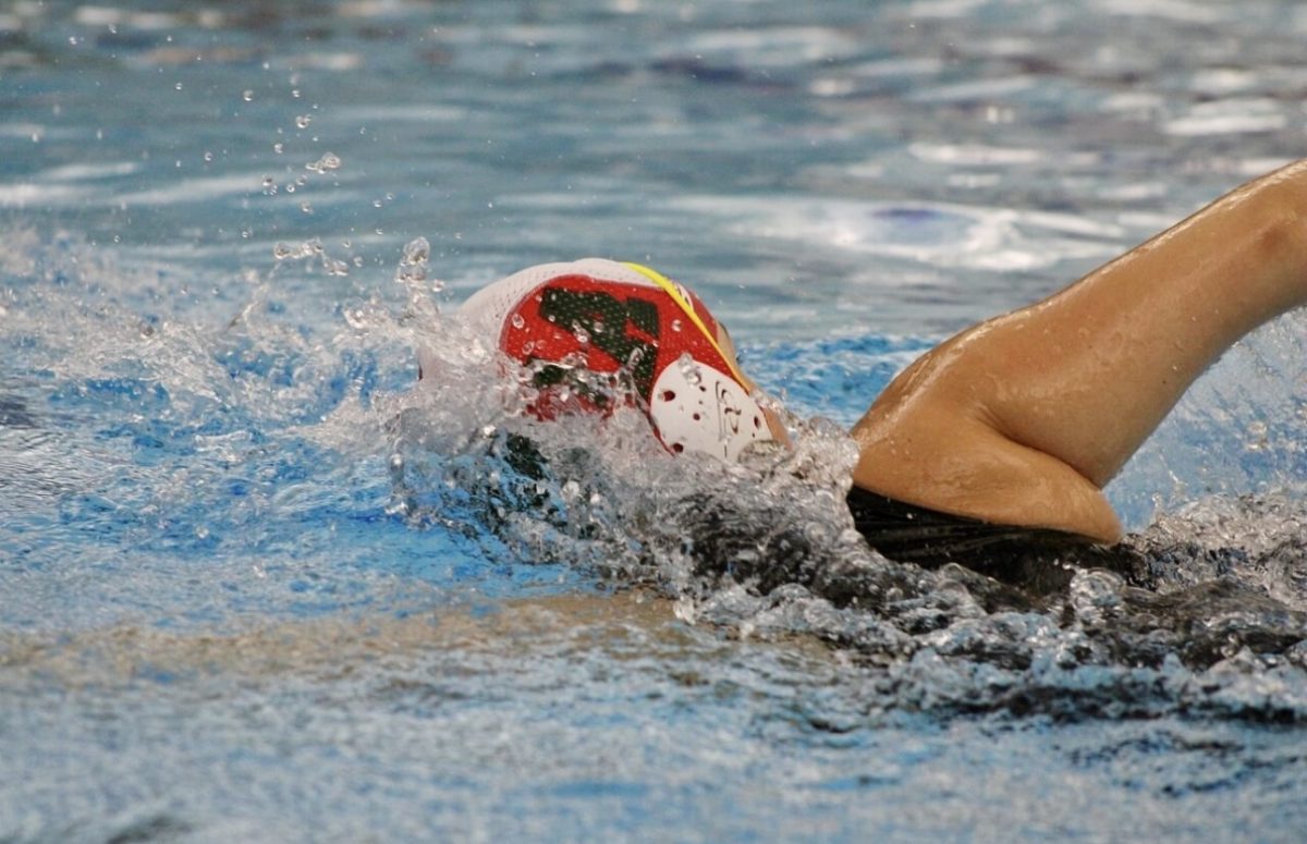 Baity Wagner swimming back to the goal at her water polo game against Grand Blanc high school.