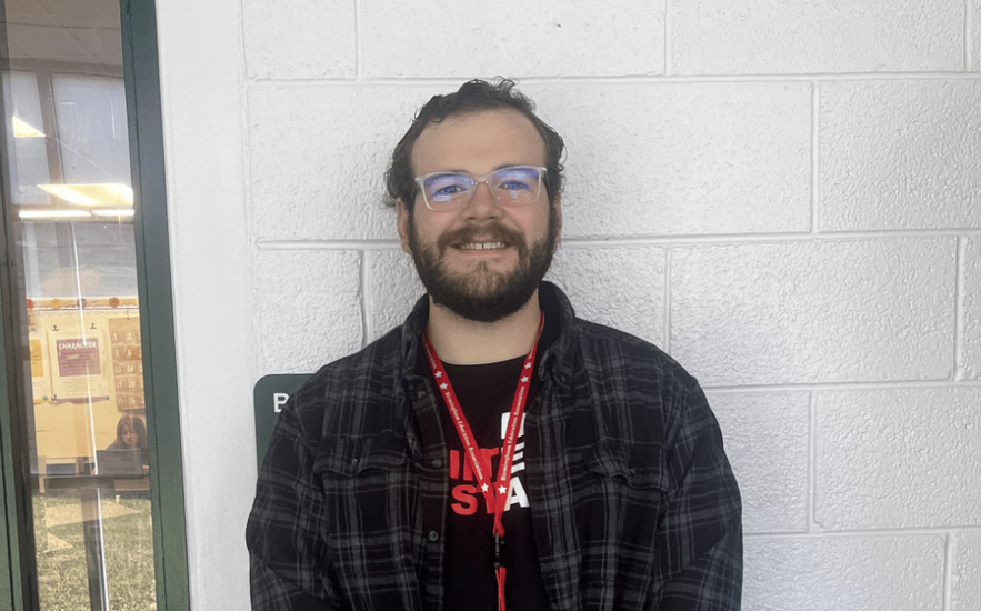 Jackson Callahan a new English teacher at Wylie E Groves High School, standing in front of his classroom.