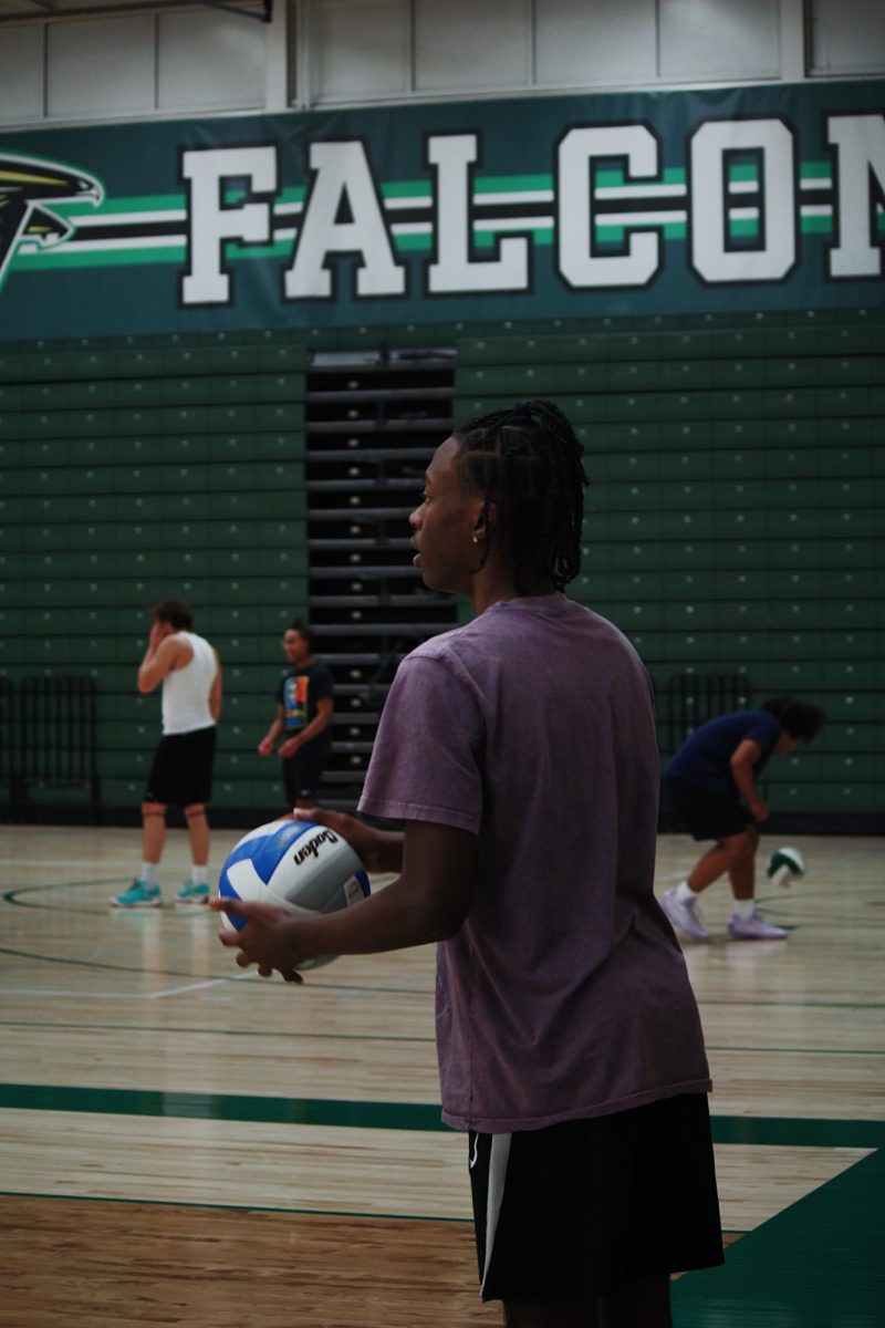 Groves Sophomore Jordan Johnson getting ready to serve.