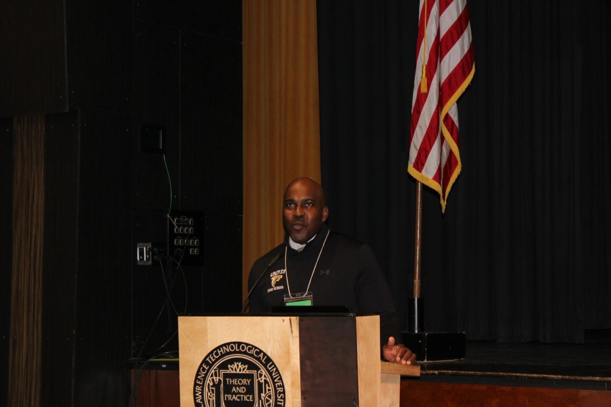 Groves Principal Othamian Peterson addressing the Class of 2026 at Senior Seminar.