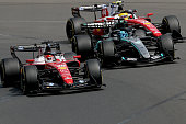 Ferrari's Monegasque driver Charles Leclerc (L) competes with Mercedes' British driver George Russell (C) and Ferrari's British driver Lewis Hamilton (R) during the Formula One Australian Grand Prix at Melbourne's Albert Park Circuit on March 8, 2026. (Photo by Martin KEEP / AFP via Getty Images) / -- IMAGE RESTRICTED TO EDITORIAL USE - STRICTLY NO COMMERCIAL USE --