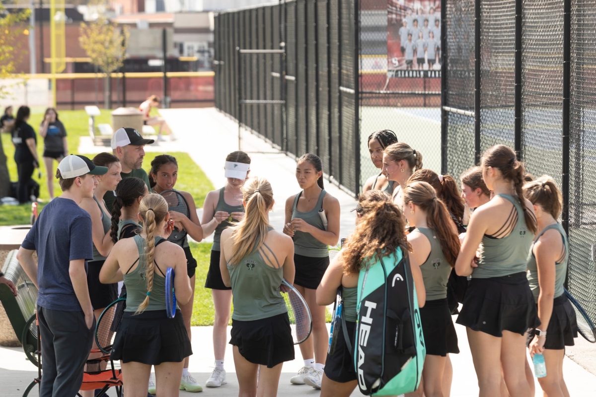 Tennis team debriefs after their match.