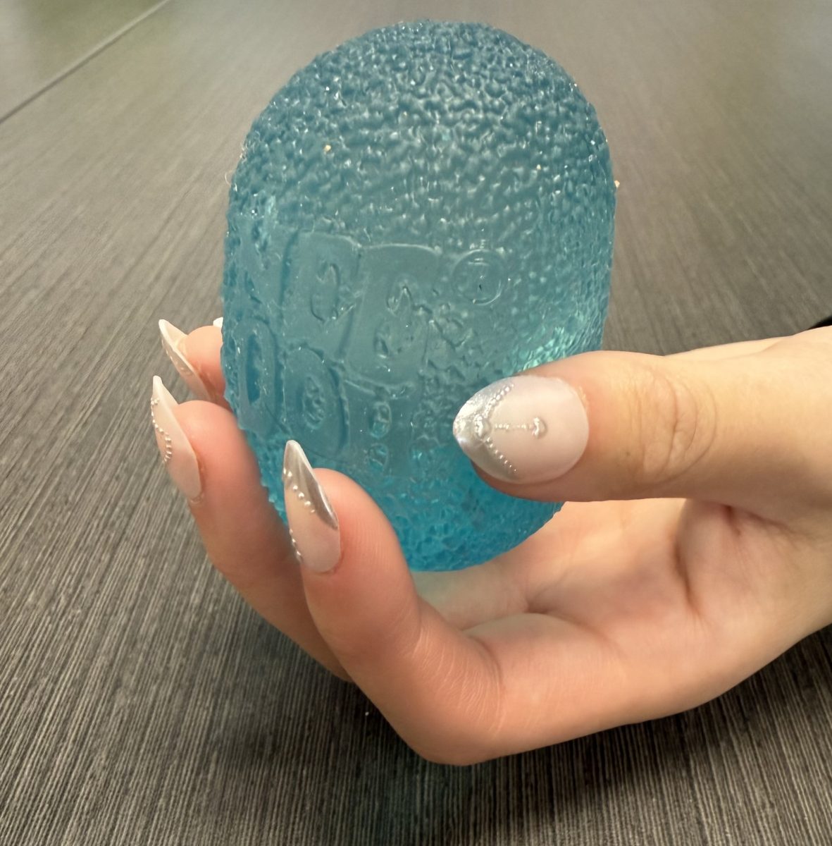 A student holding her Needoh.